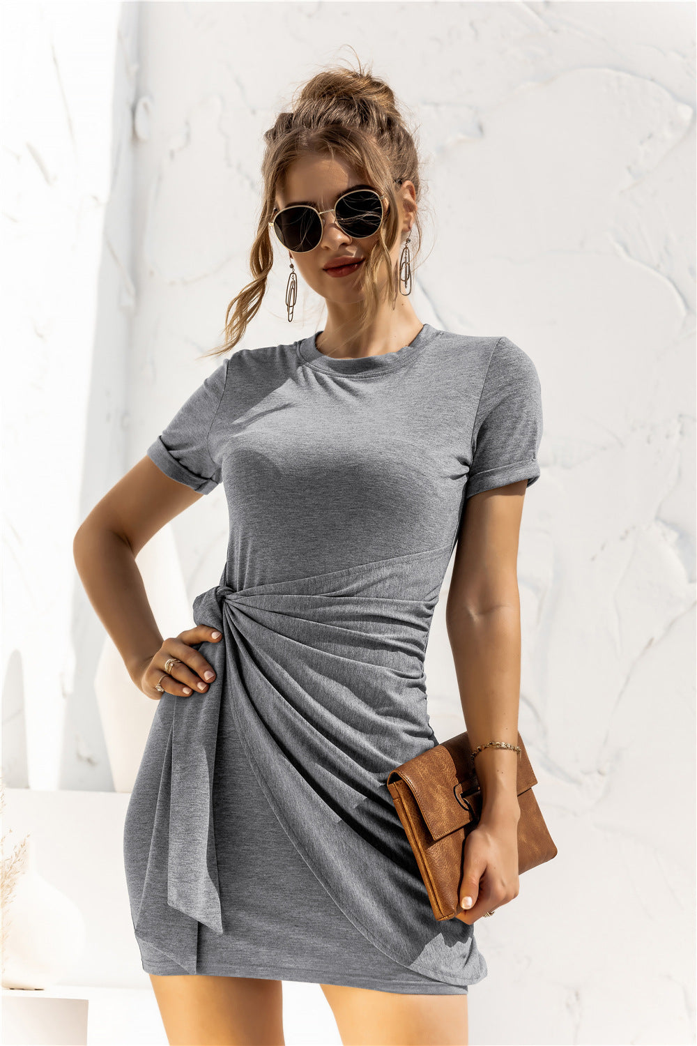 Mid Gray jersey knot-front mini dress with short sleeves and a draped skirt.