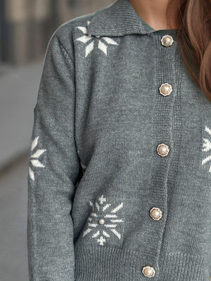 Gray acrylic knit cardigan with white snowflake pattern and pearl buttons.