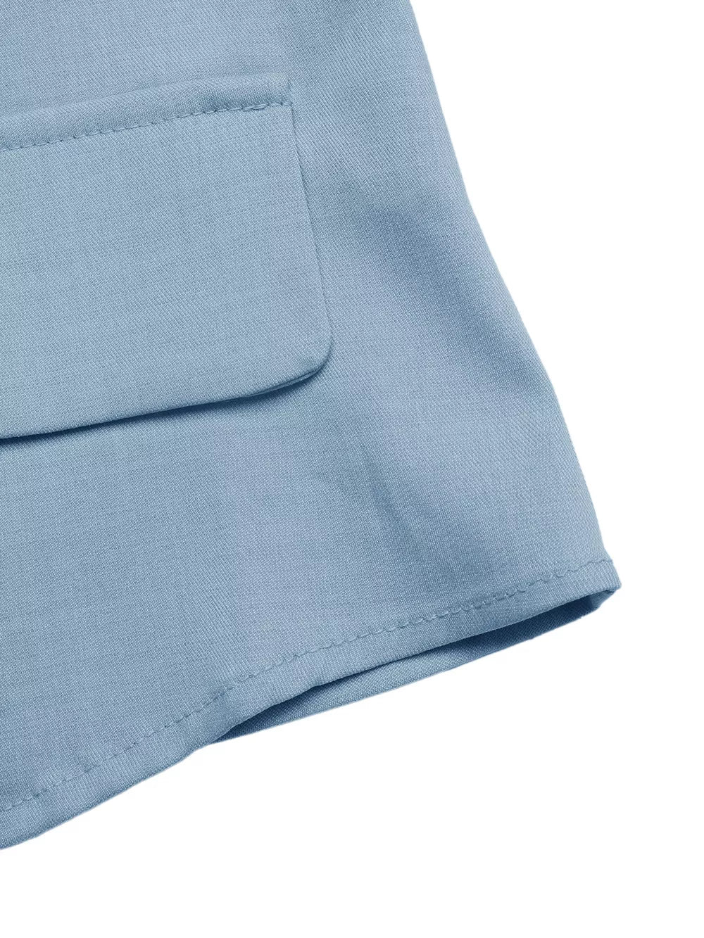 Light blue buttoned vest detail with a flap pocket and clean stitching.