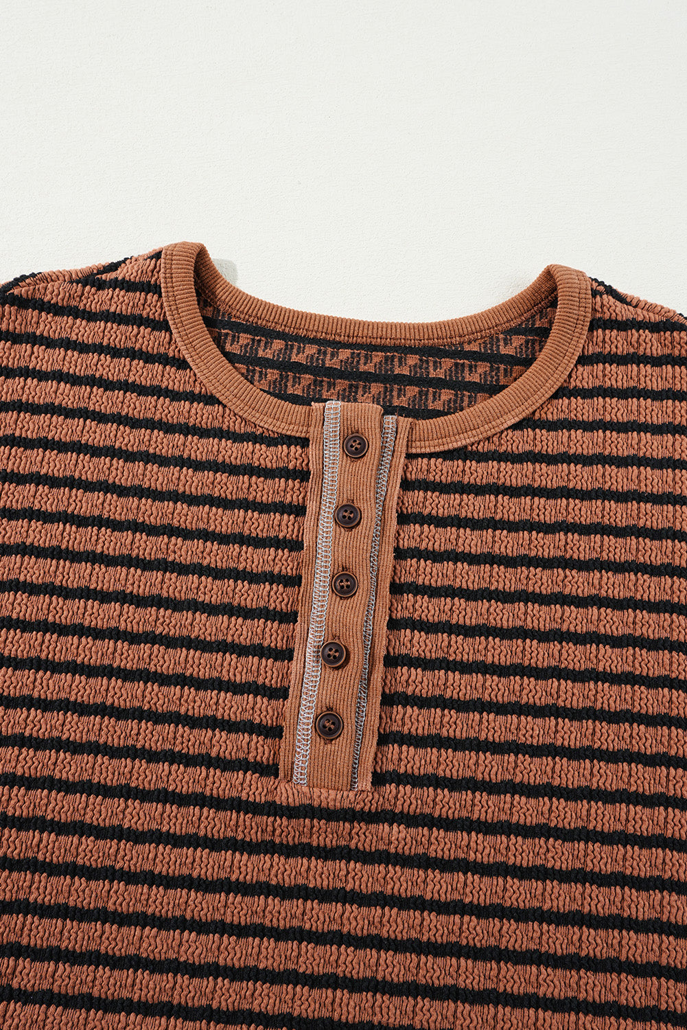Textured henley knit top in caramel with black stripes and a button placket.