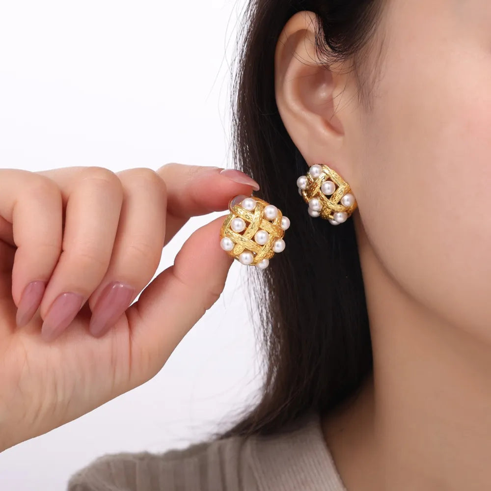 Gold woven pearl grid earrings with a textured finish.