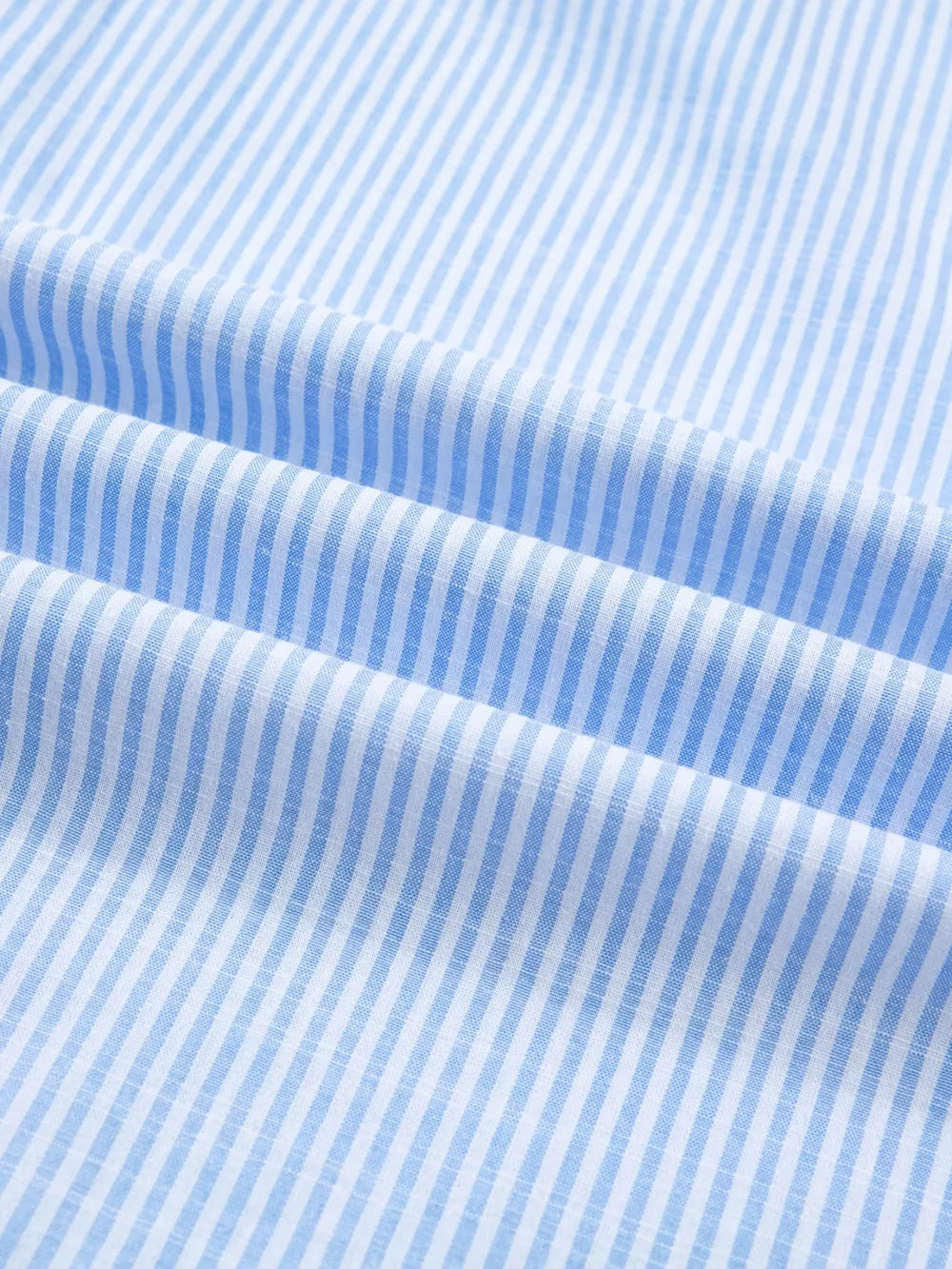 Blue and white striped button-down shirt fabric detail