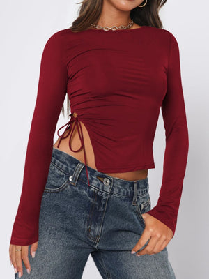 Burgundy long sleeve ruched top with adjustable side tie detail.
