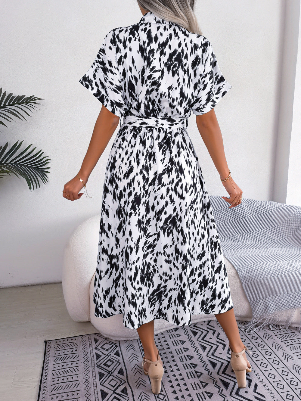 Dalmatian print midi shirt dress in white with black spots, short sleeves, and tie waist.