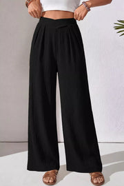 Black textured maternity wide-leg pants with a crossed waist and pleats.