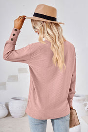 Blush pink textured v-neck blouse with button cuff detail