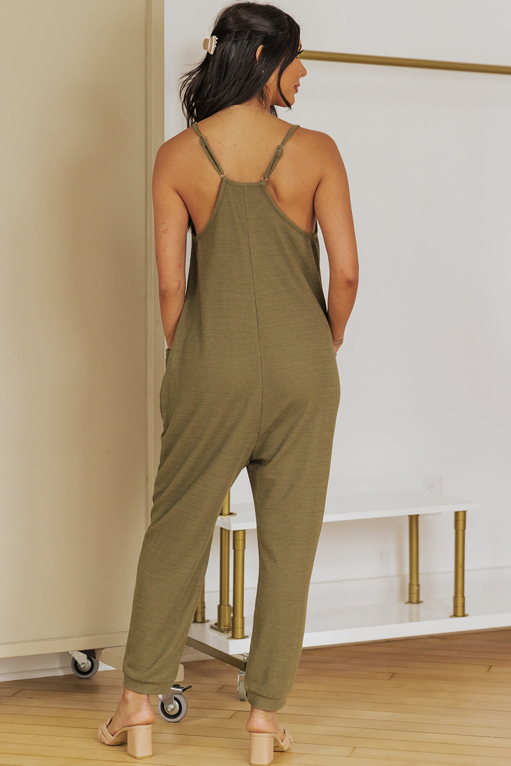 Relaxed-fit jersey jumpsuit in olive green with slouch pockets and adjustable straps.