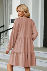 Dusty Pink textured babydoll mini dress with voluminous sleeves and tiered skirt.