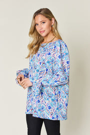 Painterly print blouse in sky blue with gathered long sleeves and a crew neck.