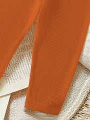 Orange ribbed baby pants with a comfortable fit