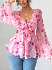 Pink floral chiffon blouse with tie-front and bell sleeves.