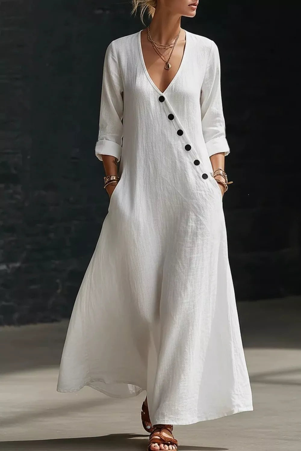 White maxi dress with V-neck, button detail, and pockets.