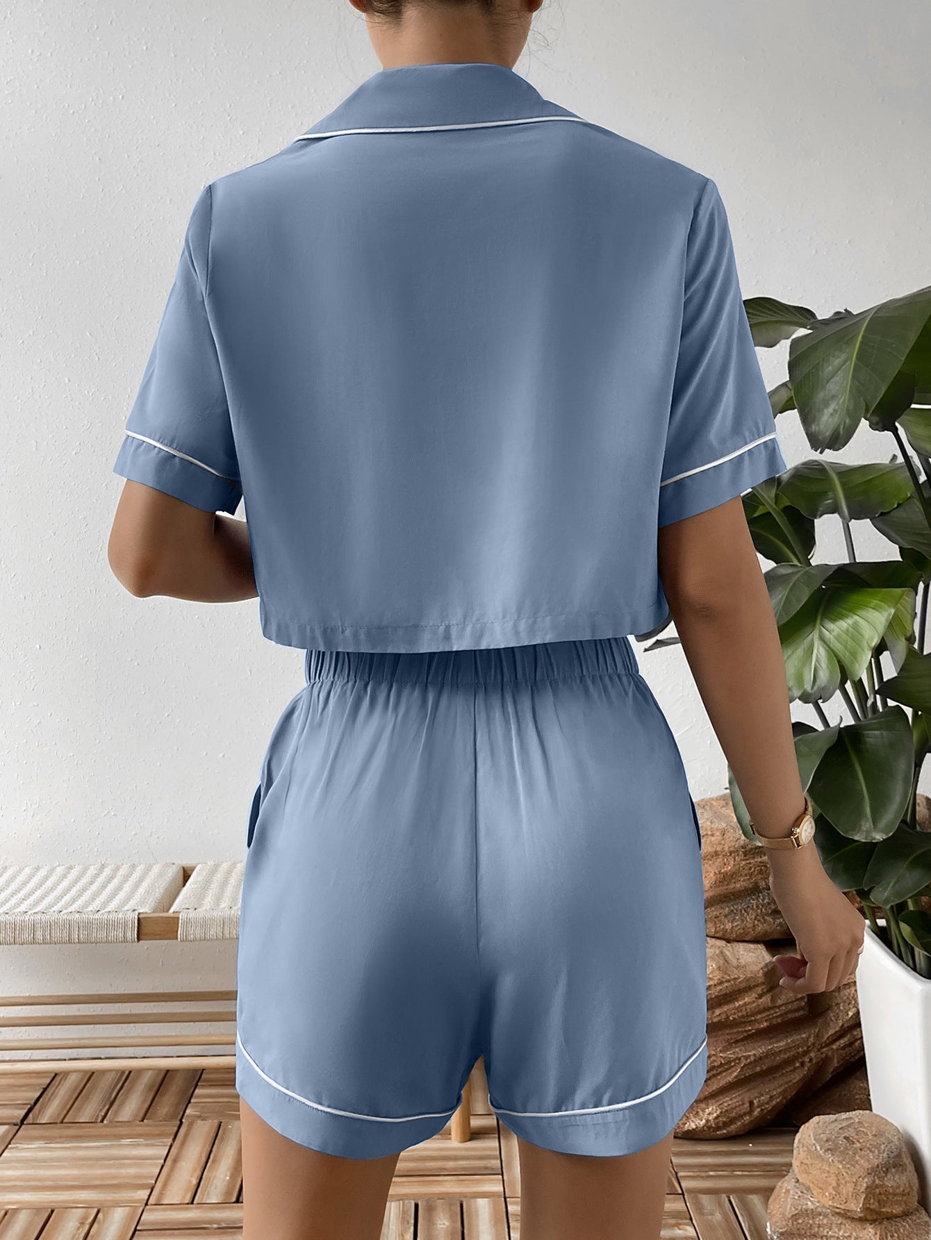 Light blue cropped pajama set with contrast trim, short sleeves, and elastic waist shorts.