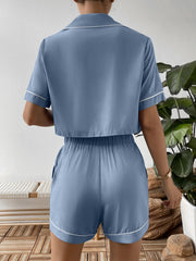 Light blue cropped pajama set with contrast trim, short sleeves, and elastic waist shorts.