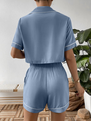 Light blue cropped pajama set with contrast trim, short sleeves, and elastic waist shorts.