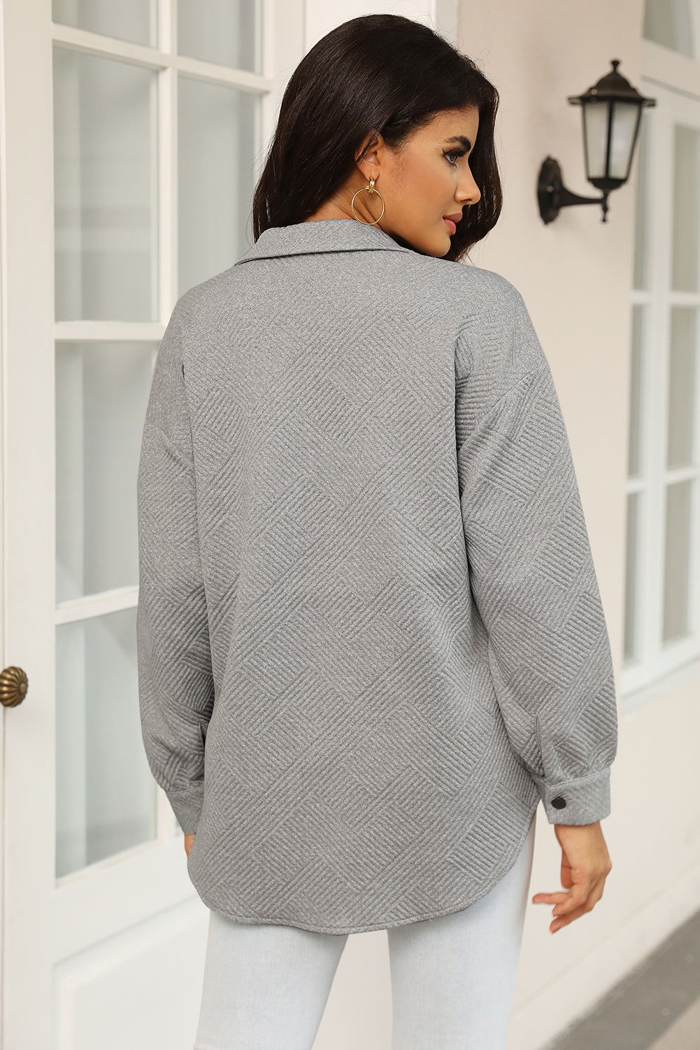 Textured grey overshirt with a geometric pattern, collared neckline, and button cuffs.