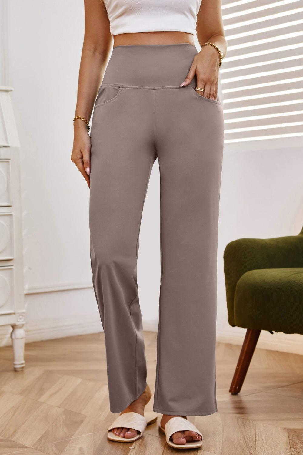 High-waisted flare leg trousers in tan with pockets, styled casually.