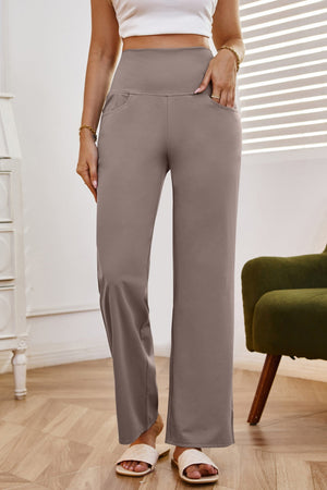 High-waisted flare leg trousers in tan with pockets, styled casually.