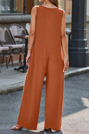Flowing palazzo jumpsuit in caramel with V-neck and wide legs.