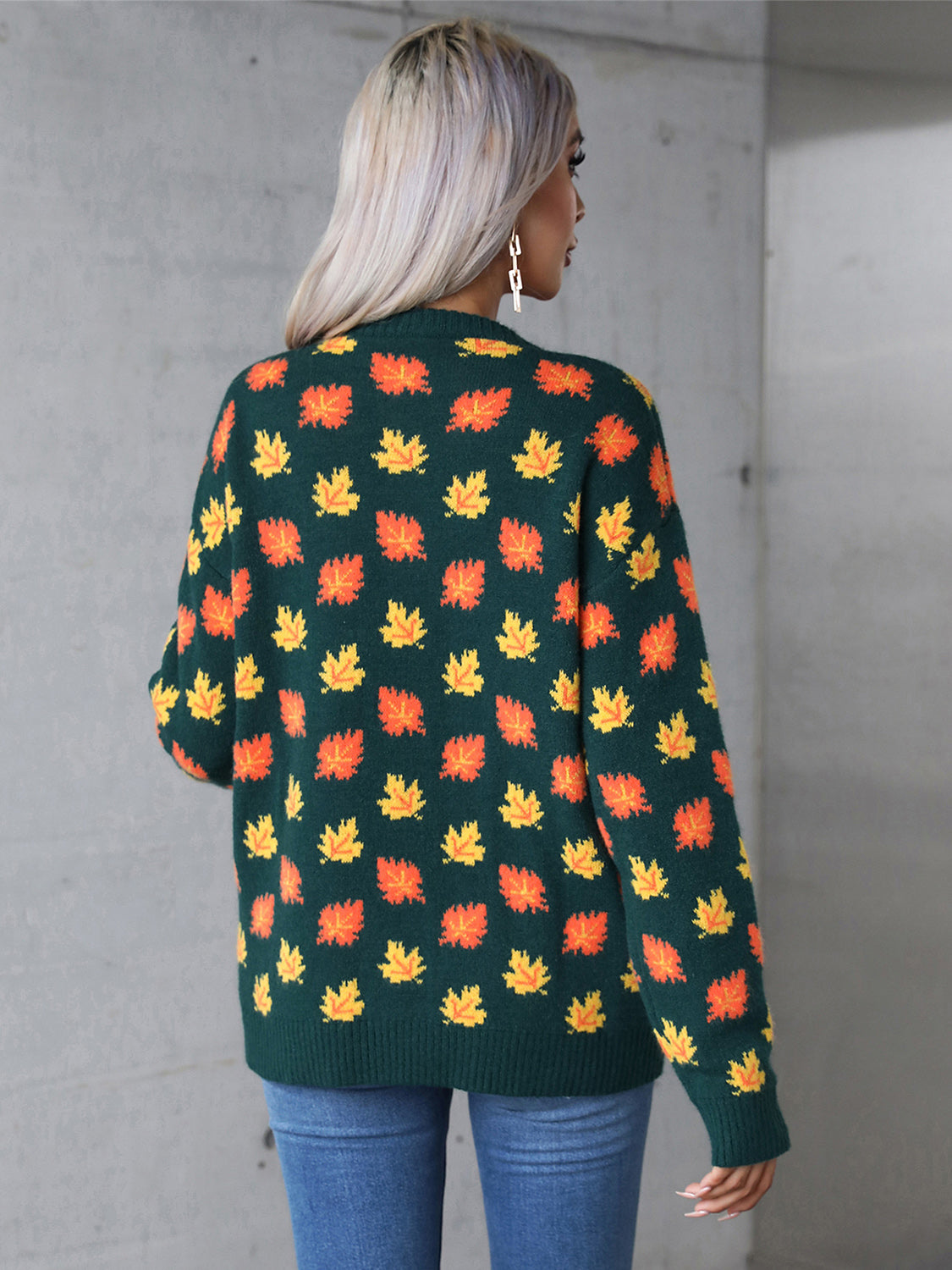 Dark green acrylic knit crewneck sweater with an all-over autumnal leaf motif.
