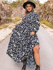 Dark navy paisley print tiered maxi dress with long sleeves and a high neckline.