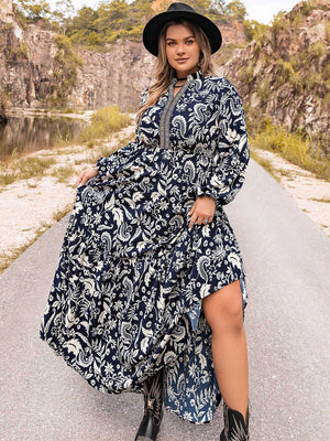 Dark navy paisley print tiered maxi dress with long sleeves and a high neckline.