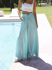 Turquoise palazzo trousers with a white pineapple print, ruffled waist, and drawstring.