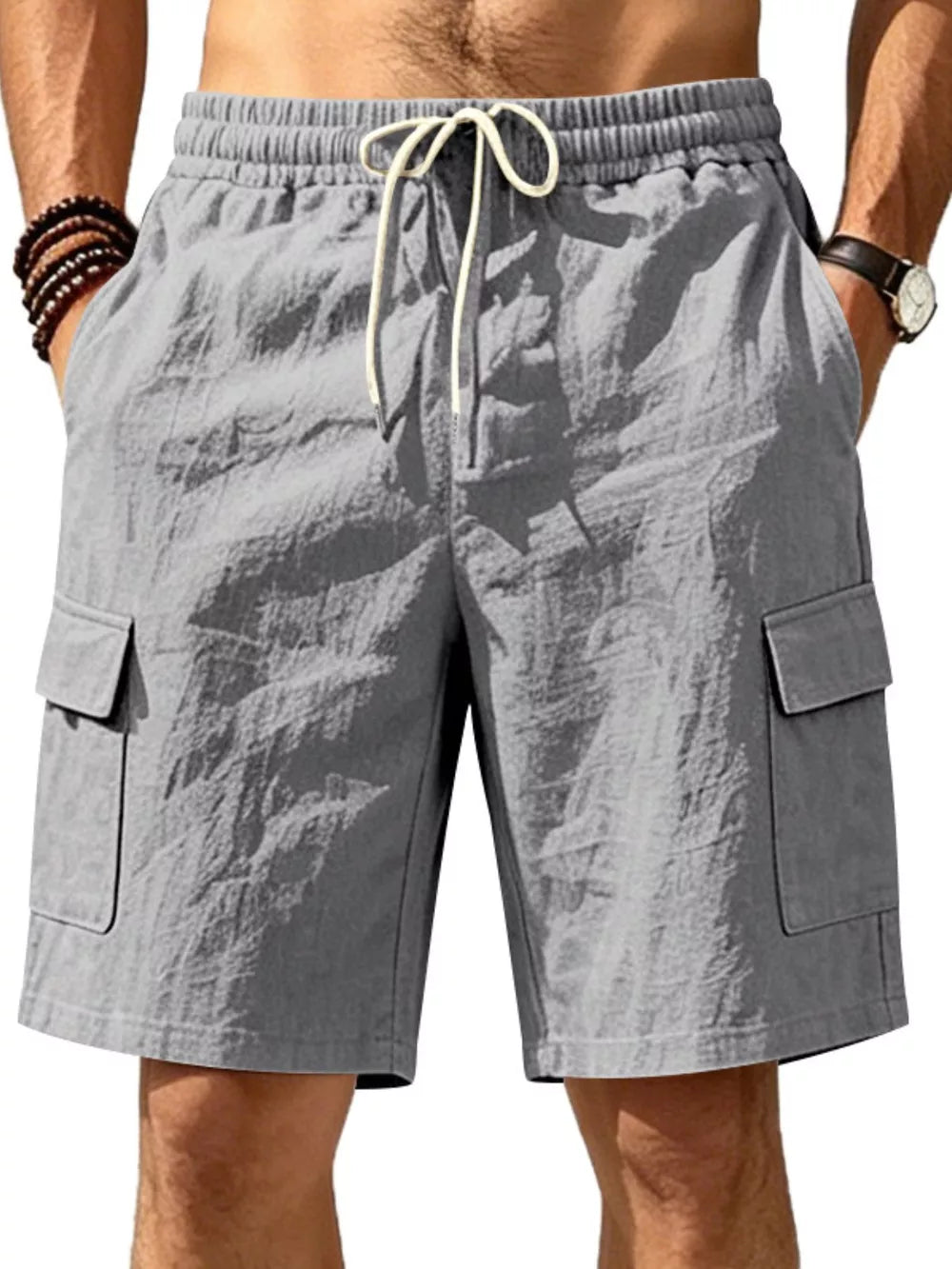 Dark gray crinkled cargo shorts with drawstring waist and buttoned flap pockets.