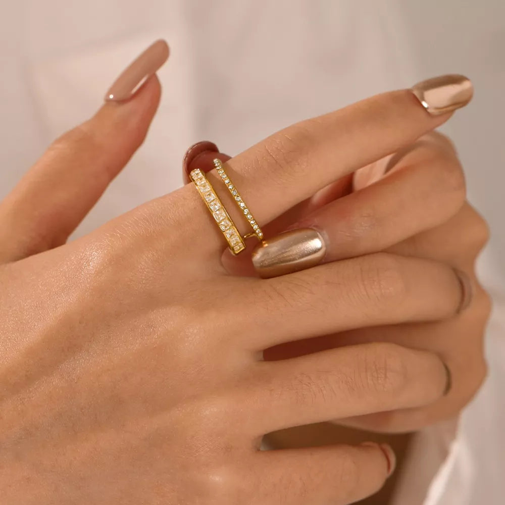 Opulent gold-plated open ring with dual bands and baguette rhinestones.