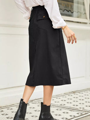 Black midi skirt with pinstripe texture, buttoned pocket detail, and elastic waistband.