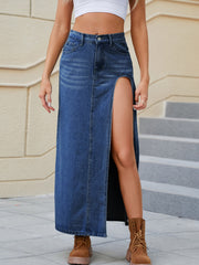 Denim maxi skirt in medium wash with a high slit and buttoned front.