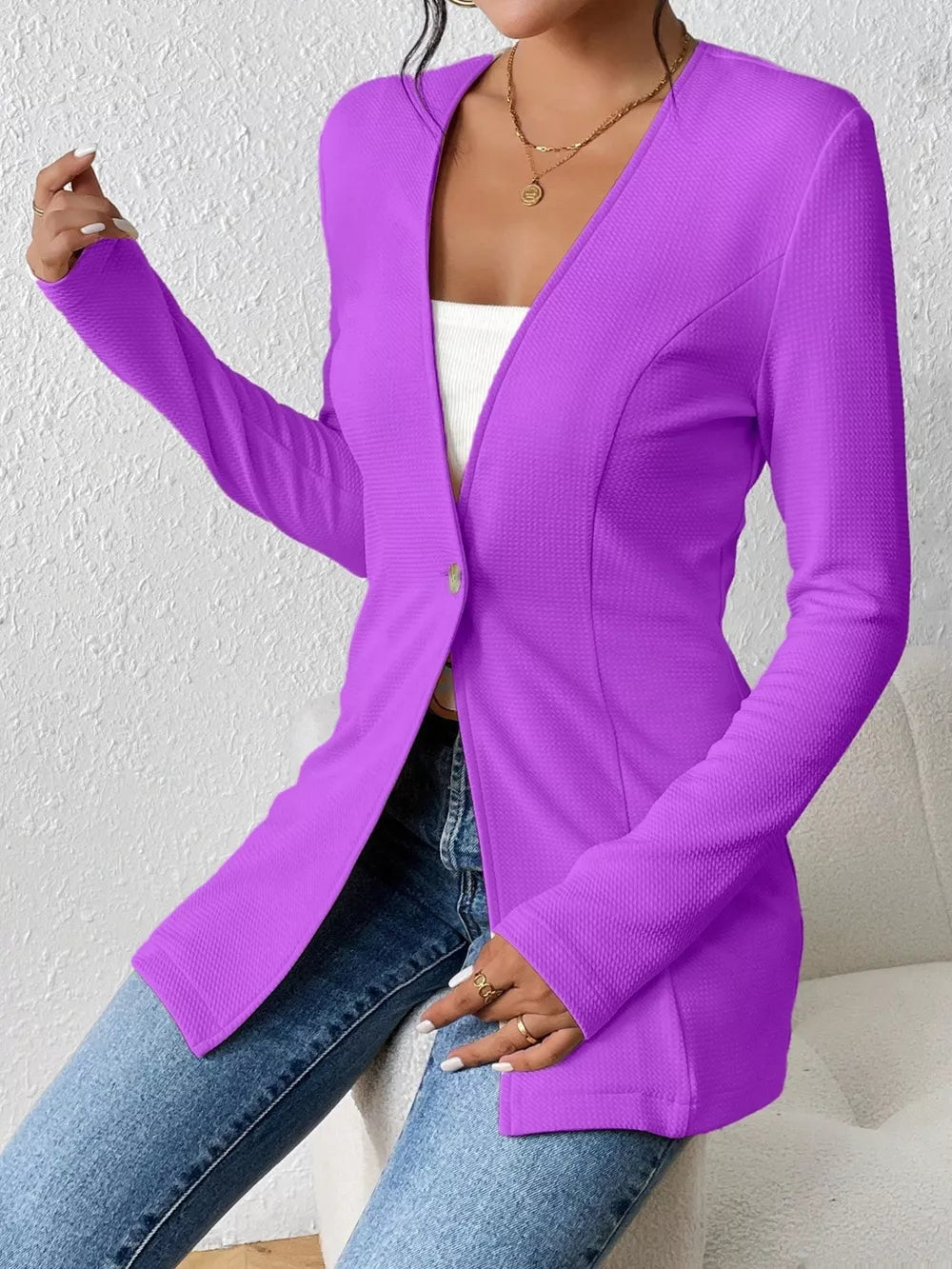Purple single-button blazer with tailored fit and textured fabric.