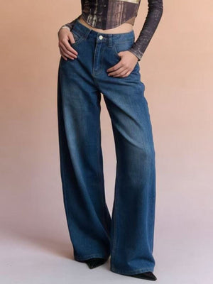 Cutout high-waisted wide-leg jeans in blue denim with button closure and pockets.