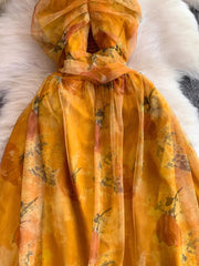Yellow floral layered mesh maxi dress with ruched bodice detail.
