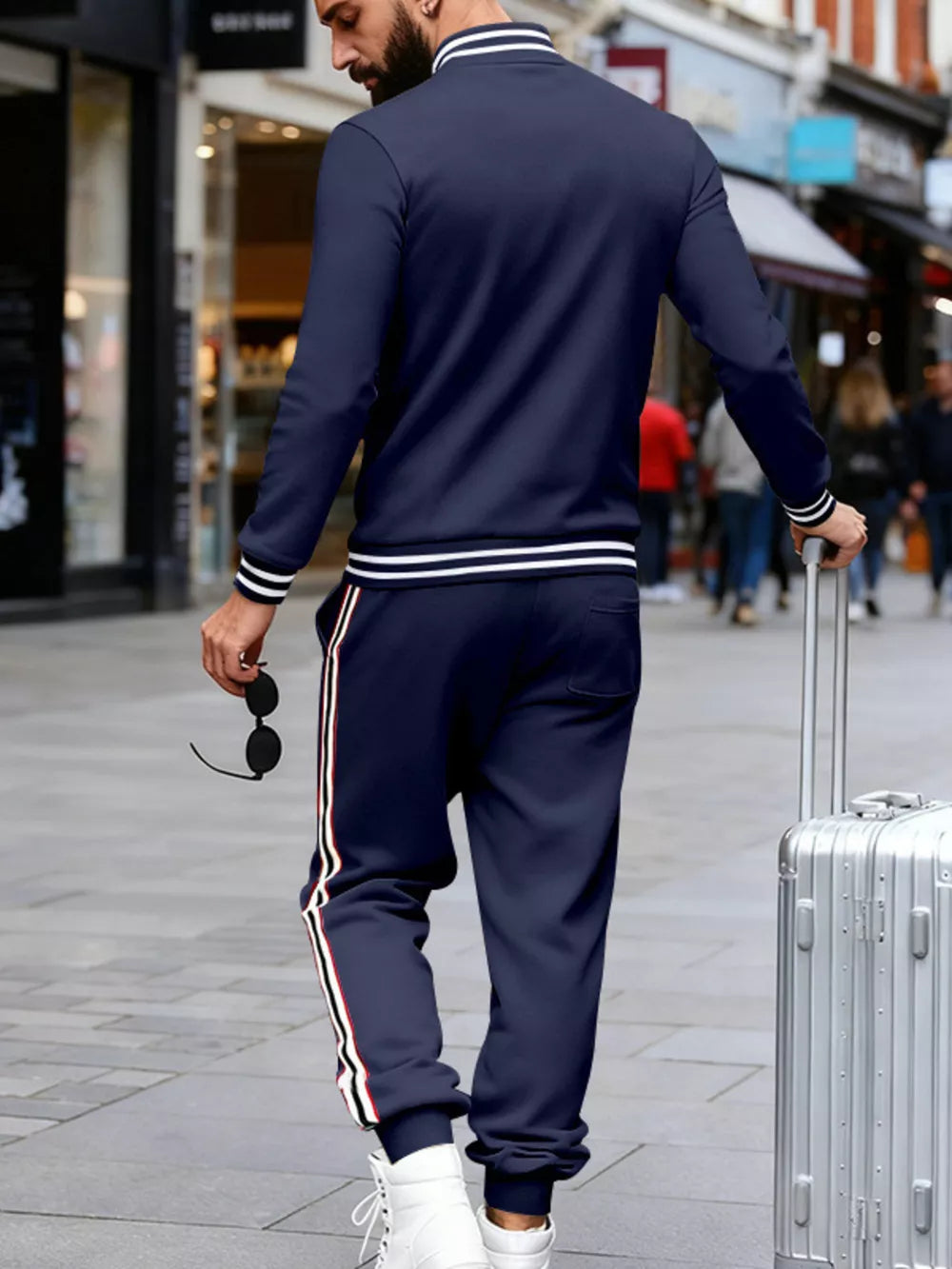 Navy striped track pants with side stripes and ribbed cuffs.