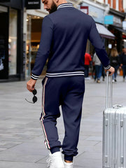 Navy striped track pants with side stripes and ribbed cuffs.