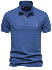 Blue piqué polo shirt with giraffe embroidery and striped collar detail.