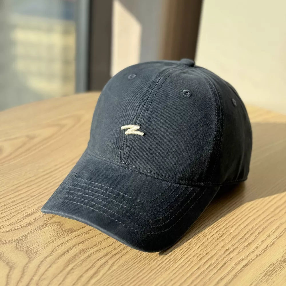 Distressed navy blue cotton baseball hat with curved brim and embroidered detail.