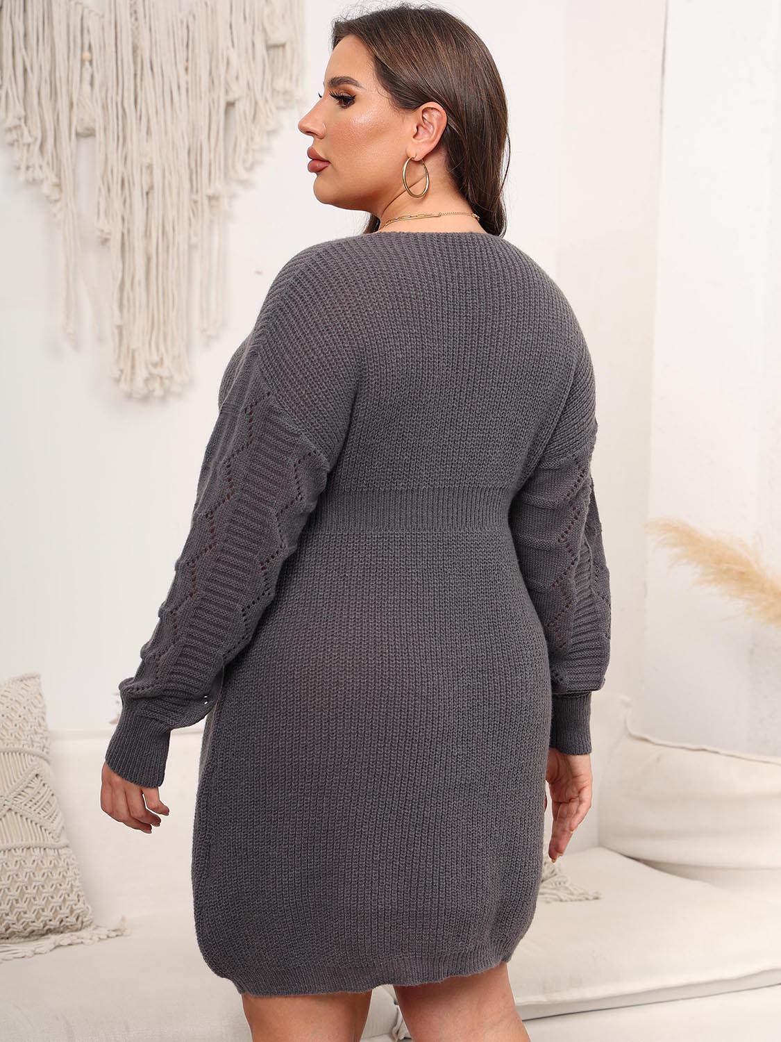 Charcoal knit midi dress with V-neck and textured sleeves.