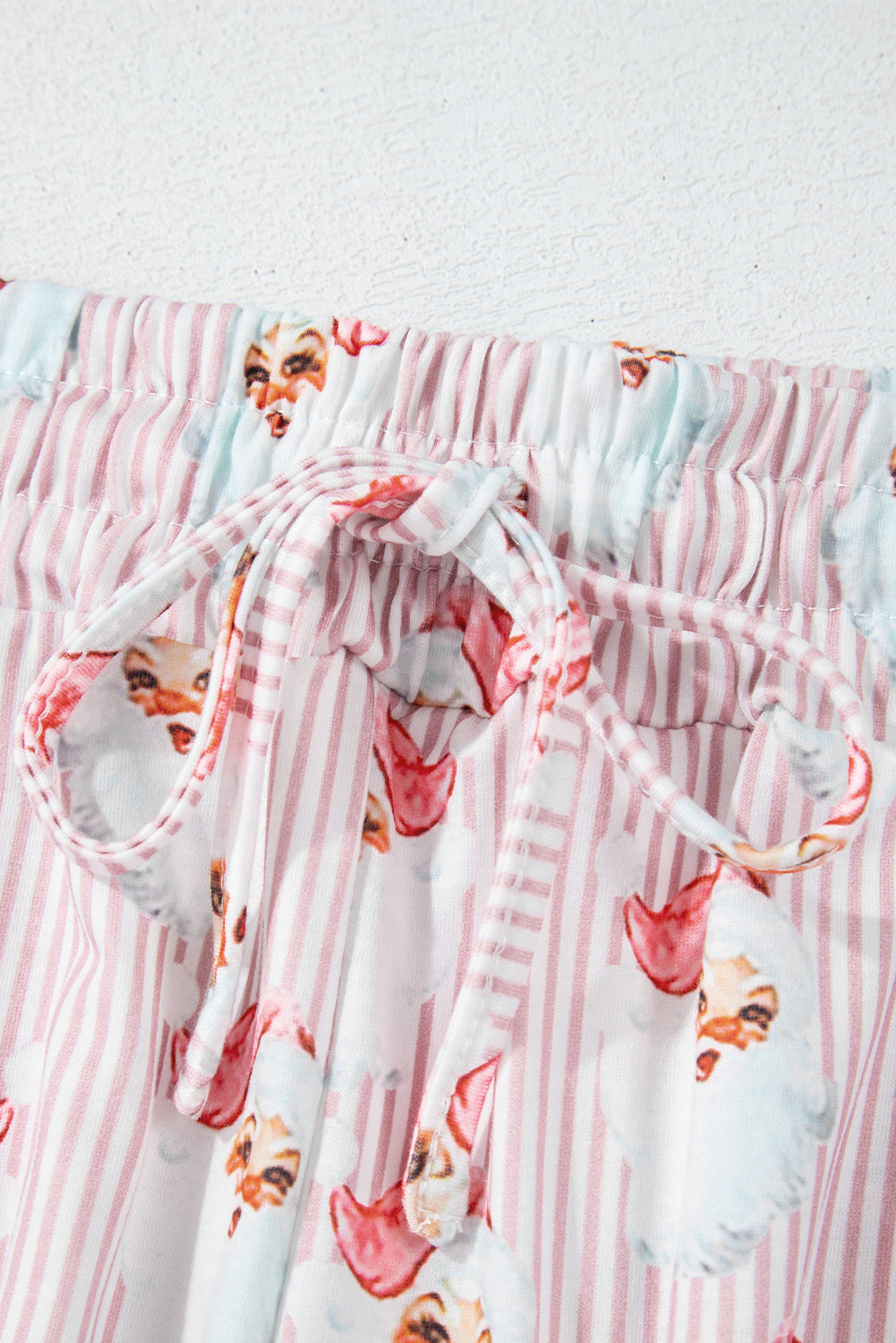 Loungewear set with pink stripes and Santa print, featuring a drawstring waist.