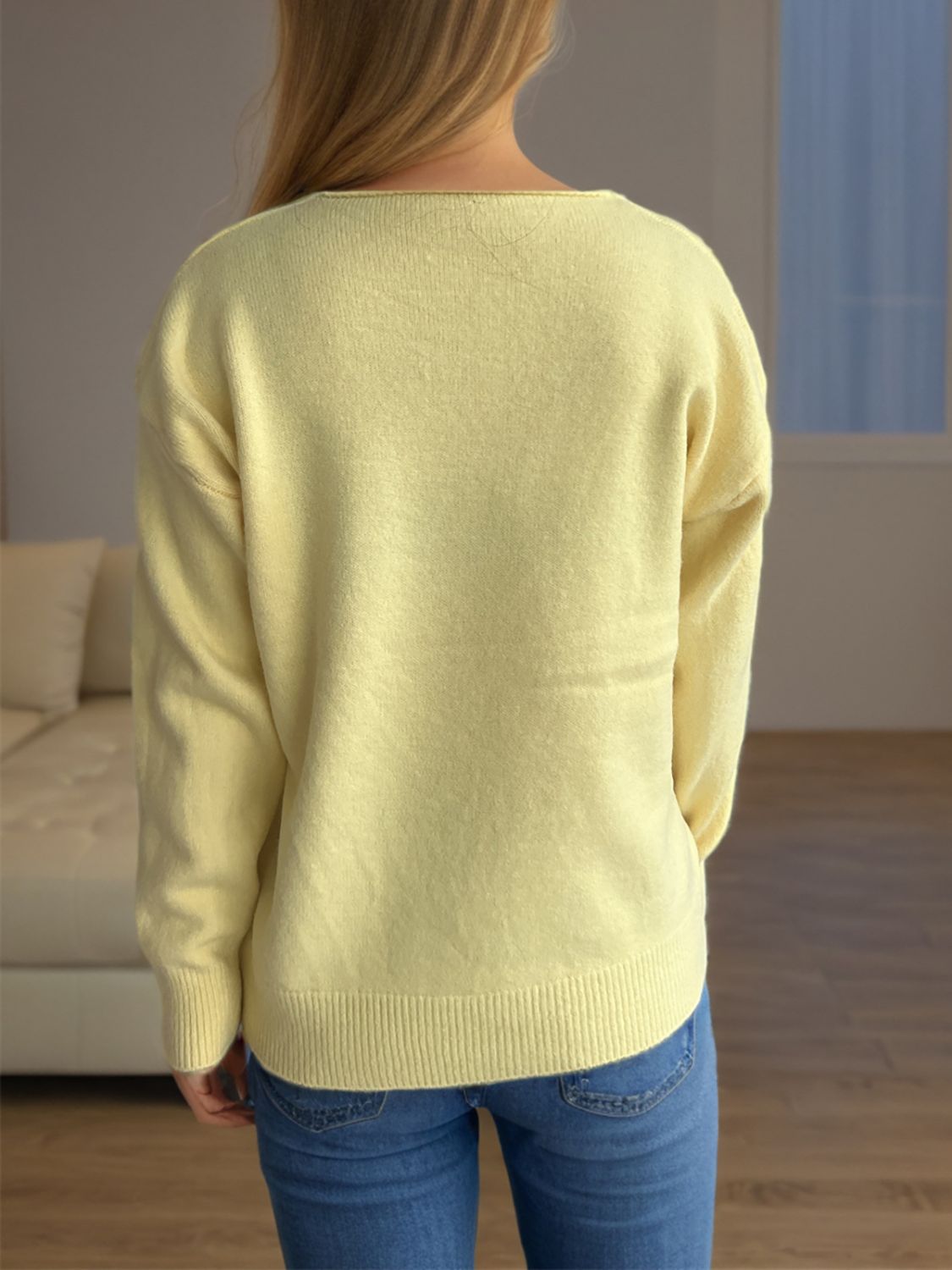 Light yellow acrylic V-neck knit sweater with ribbed hem and cuffs.