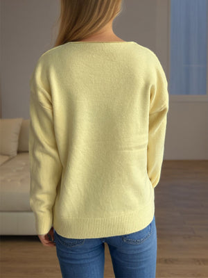 Light yellow acrylic V-neck knit sweater with ribbed hem and cuffs.