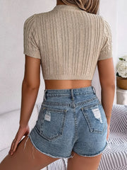 Tan cable knit crop top with openwork detail and short sleeves.