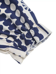 Maxi dress with navy floral print, ruffled sleeve detail and cutout waist.