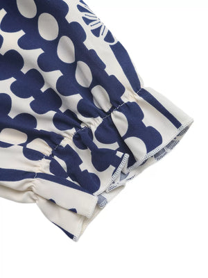 Maxi dress with navy floral print, ruffled sleeve detail and cutout waist.