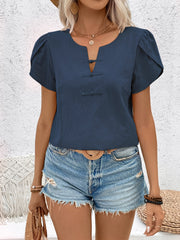Indigo linen blouse with mandarin collar, puff sleeves, and knot button detail.