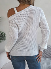 White one-shoulder knit sweater with asymmetrical strap detail and textured pattern.