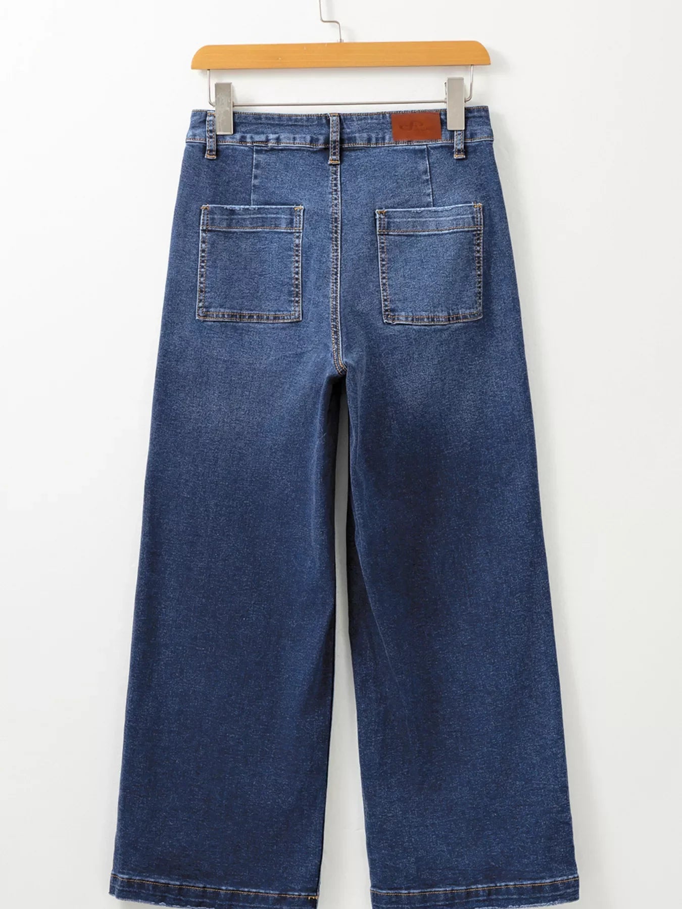 Patch pocket wide-leg jeans in medium wash denim with a relaxed fit.
