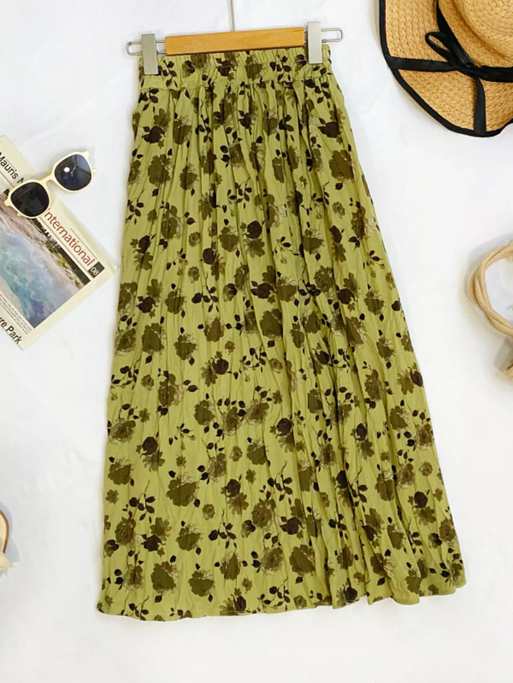Botanical pleated midi skirt in olive with a crinkled texture and floral print.