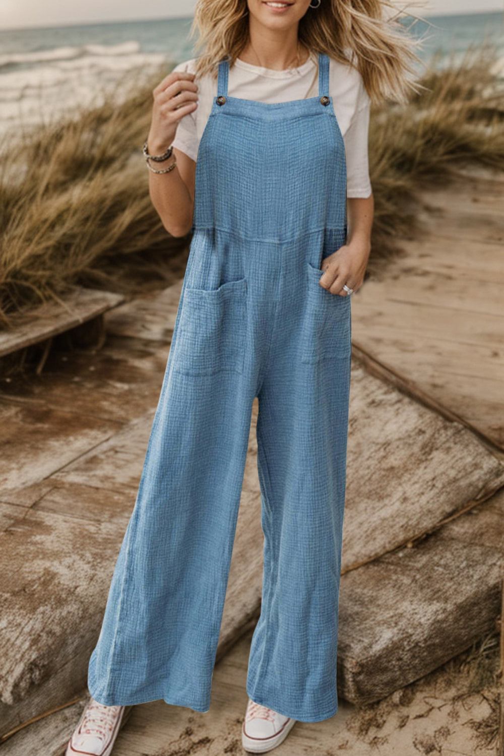Light blue textured cotton overalls with square pockets and wide legs.